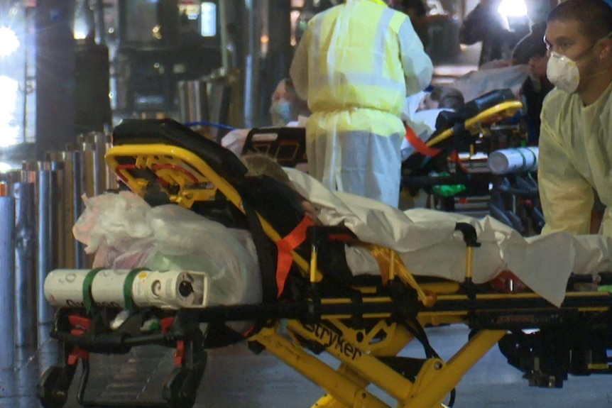 A paramedic pushes a patient on a stretcher