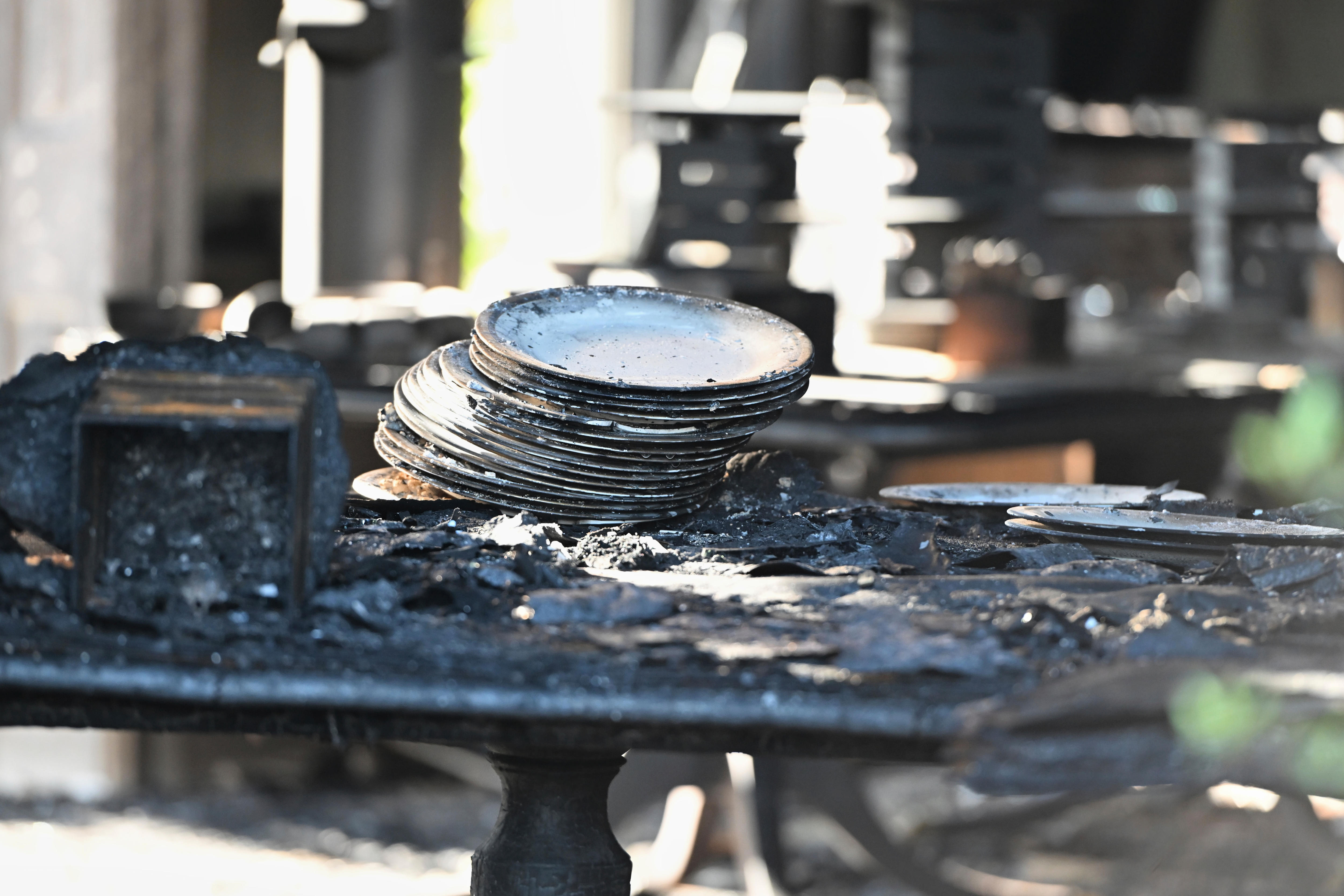 Calculated plates, a table and other utensils coated in black soot