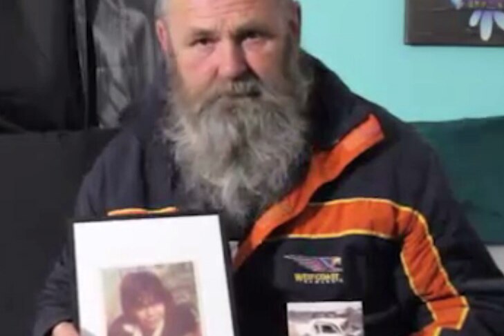 Crash survivor Michael Boyd holds photos of his best friend and the car crash that took his life.