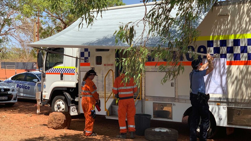 Large police vehicle with an officer and state emergency service volunteers out the front