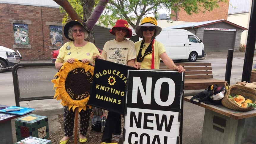 Gloucester Knitting Nannas standing with "No Coal" placards in the centre of town.