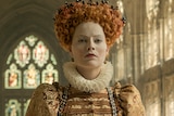 Colour still of Margot Robbie Queen Elizabeth I in 2018 film Mary Queen of Scots.