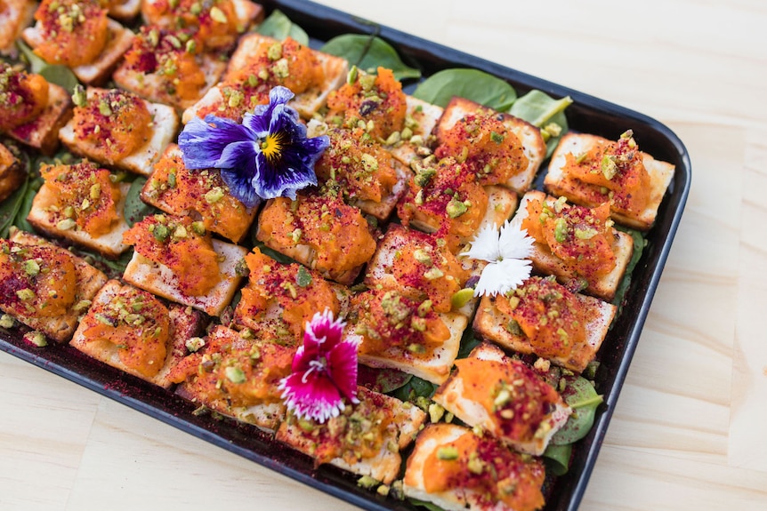 Bush yam carrot pistachio pate on grilled Haloumi squares with Davidson plum dust.