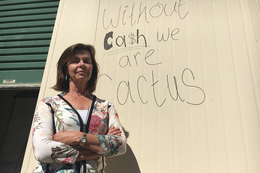 Anni Brownjohn, owner of Right Food Group, standing in front of her warehouse with a scrawled message on the walls.