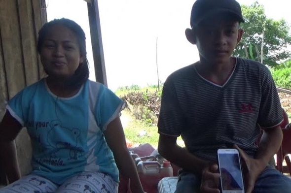 A 14-year-old girl sits next to her 16-year-old husban.