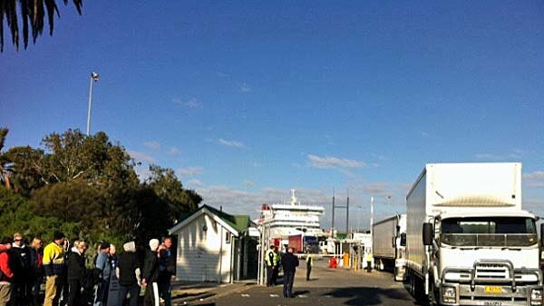 Freight trucks move through the gates of Station Pier Melbourne after driving off the Spirit of Tasmania.