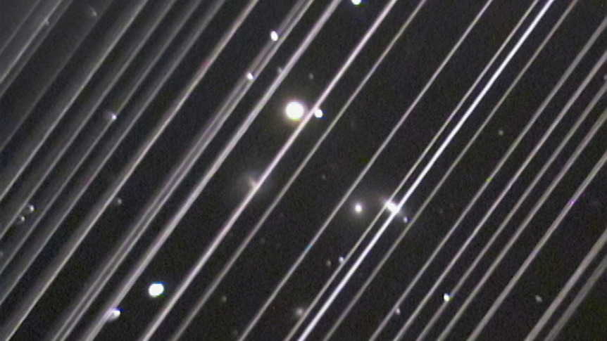 An image of Starlink satellite streaks in the sky.