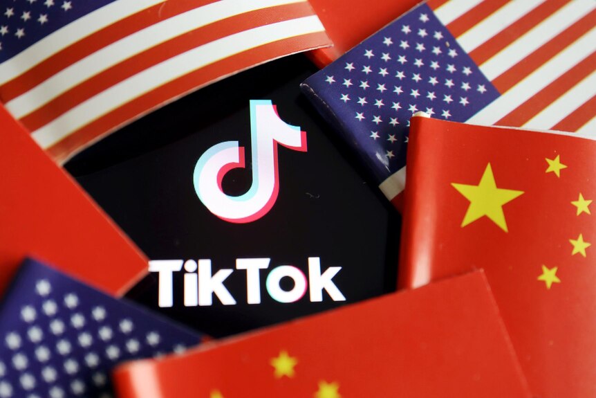 The TikTok logo with the United States and China flags surrounding it 
