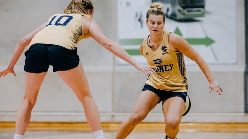 WNBL player Shyla Heal dribbling the ball with a teammate defending her at training