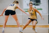 WNBL player Shyla Heal dribbling the ball with a teammate defending her at training
