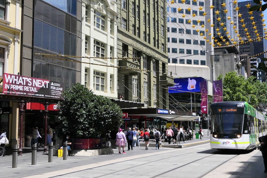 A small number of pedestrians walk down Bourke St Mall on a sunny day.