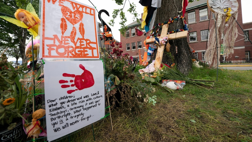 Signs are pictured at a memorial outside the Residential School in Kamloops, British Columbia