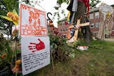 Signs are pictured at a memorial outside the Residential School in Kamloops, British Columbia