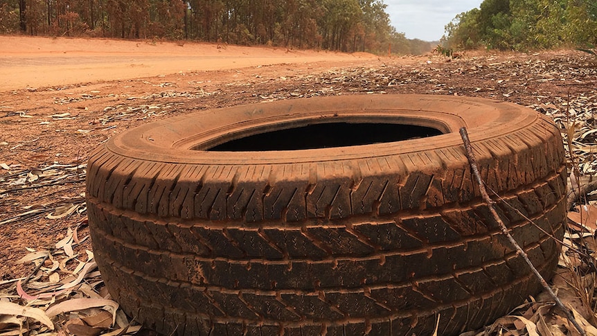 An abandoned tyre gathers red dust along the remote Peninsula Developmental Road in far north Queensland.