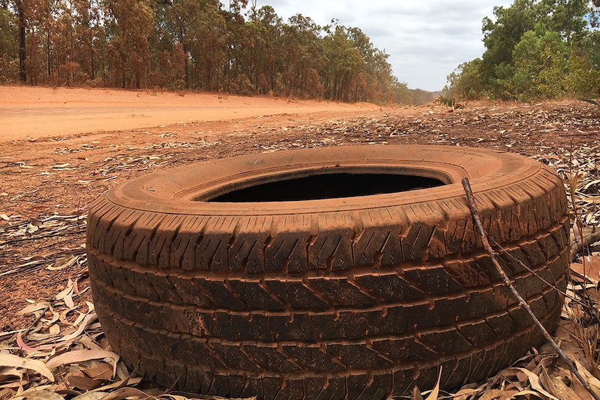 An abandoned tyre gathers red dust along the remote Peninsula Developmental Road in far north Queensland.