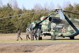 Members of the Ukrainian delegation disembark from a helicopter