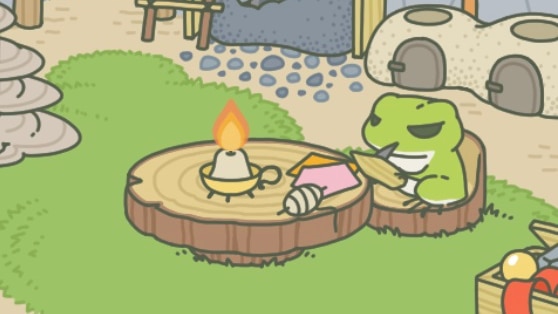 A screen shot from the game Travel Frog. The frog is sitting at a table carving a piece of wood.