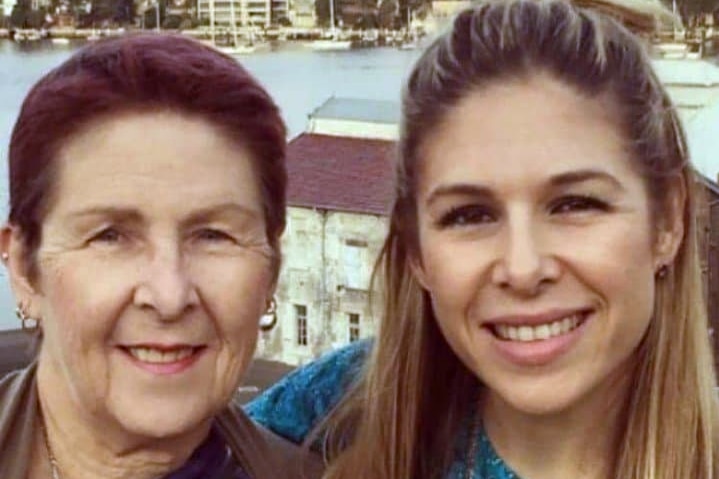 Two women standing with the Sydney Harbour Bridge in the background