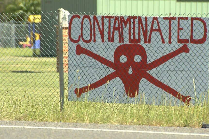 A sign shows a red scull and bones and reads "contaminated".