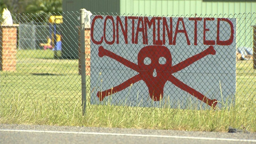 A sign shows a red scull and bones and reads "contaminated".