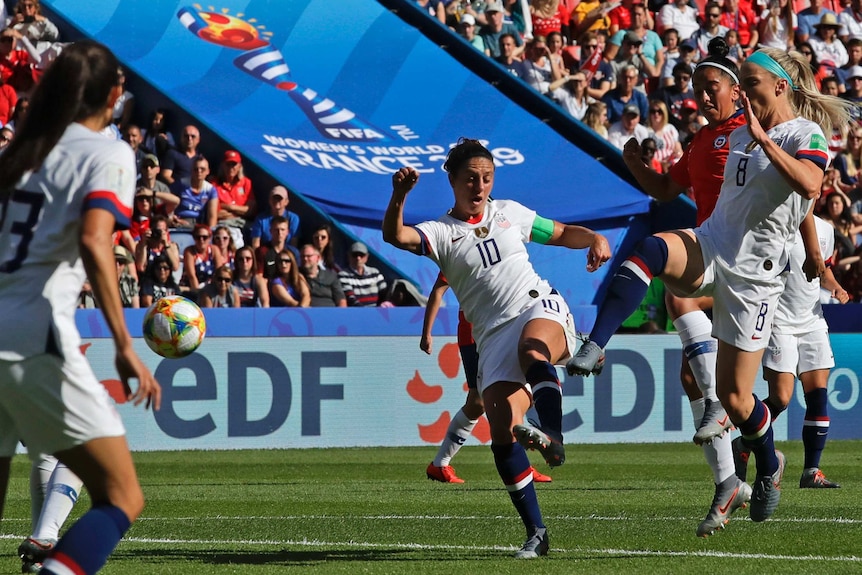 A soccer player whirls and connects with the ball to score a goal at the Women's World Cup.