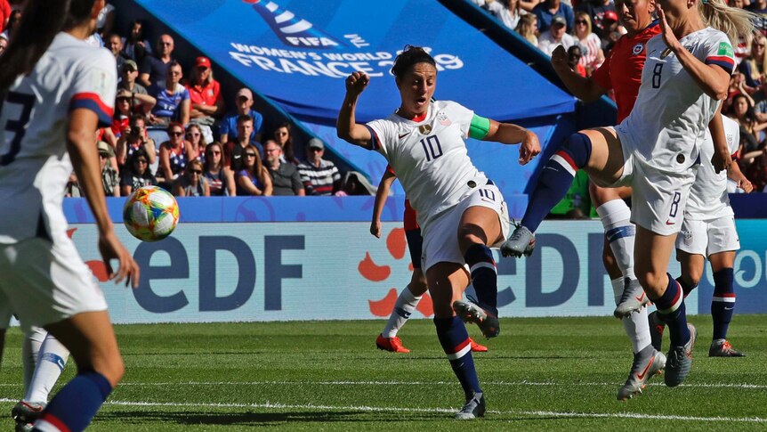 A soccer player whirls and connects with the ball to score a goal at the Women's World Cup.