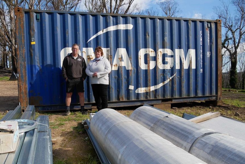 Greg and Mark Brick standing in front of a shipping container on their farm