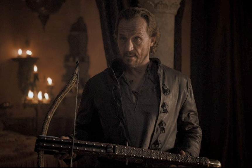 Bronn holds a crossbow.