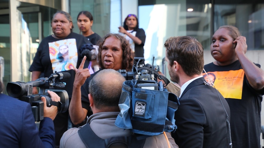 A photo of Bernadette and Bonita Clarke in front of media crews outside court.