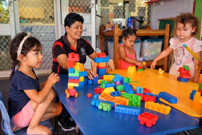 A childcare workers plays with kids at Casuarina Childcare Centre.