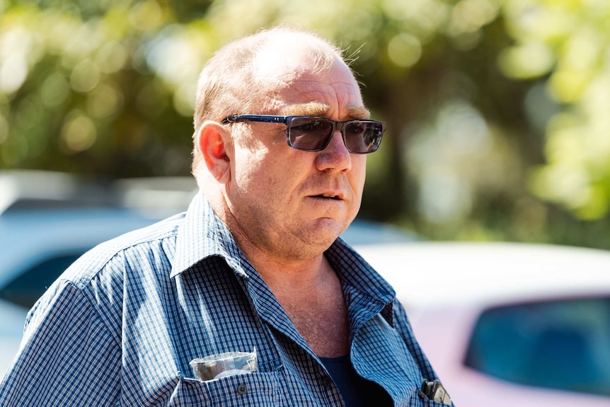 Close up of a man wearing sunglasses.