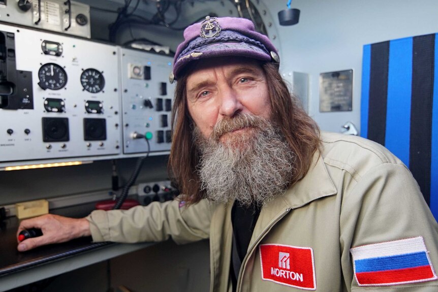 Fedor Konyukhov wearing a sailor-style cap, in the control room of his balloon.