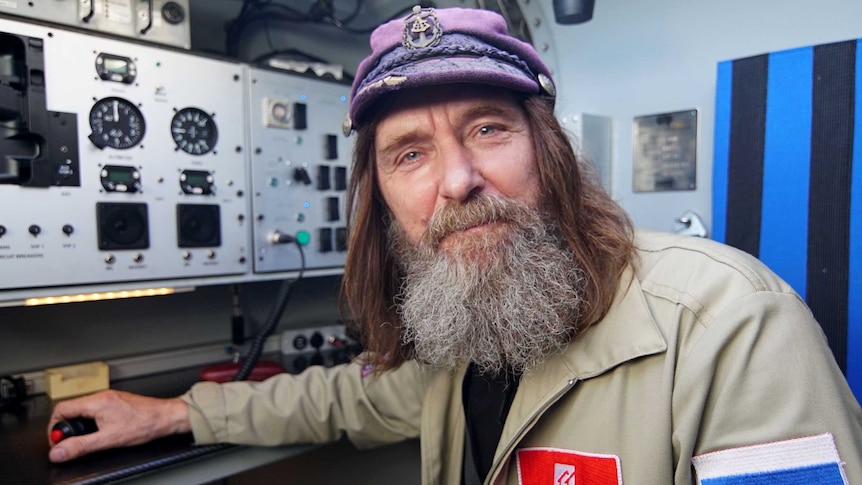 Fedor Konyukhov wearing a sailor-style cap, in the control room of his balloon.