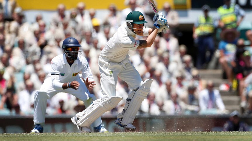 Show of aggression ... Michael Clarke drives to the mid-off boundary.