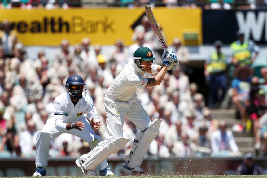 Show of aggression ... Michael Clarke drives to the mid-off boundary.