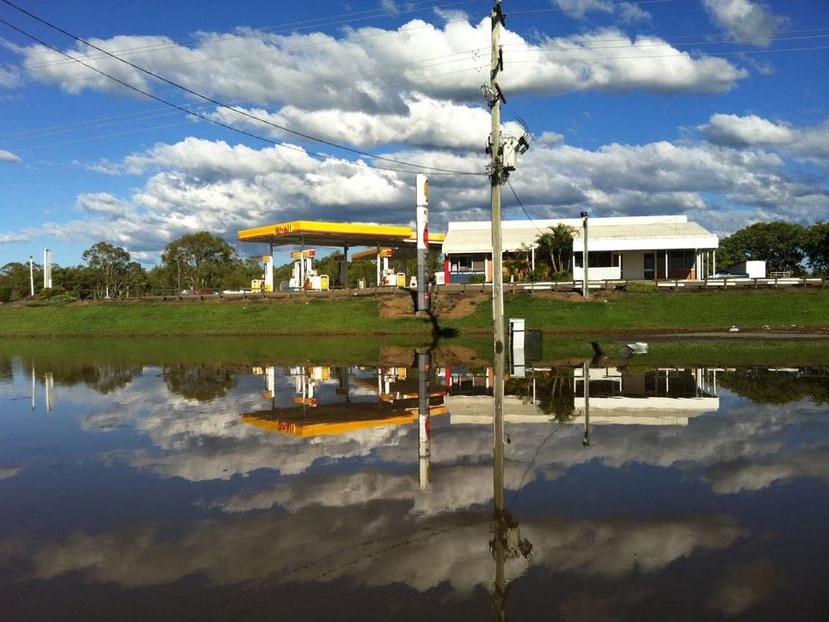 Floodwaters surround the Shell service station in Jimboomba