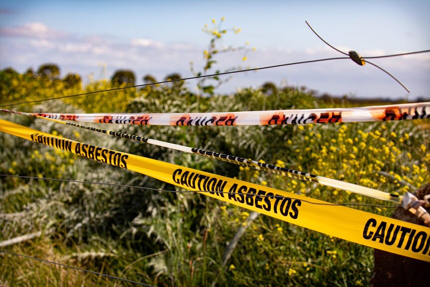 Grasslands behind a asbestos sign