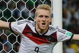 Andre Schuerrle wheels away after scoring for Germany