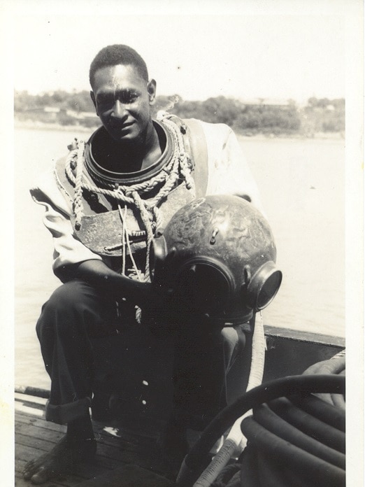 A black and white photo of Seaman Dan in pearl diving gear.