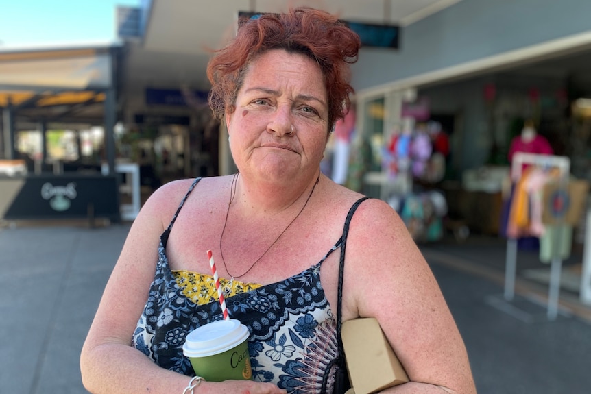 Stacey Pinci stands outside a shop front.