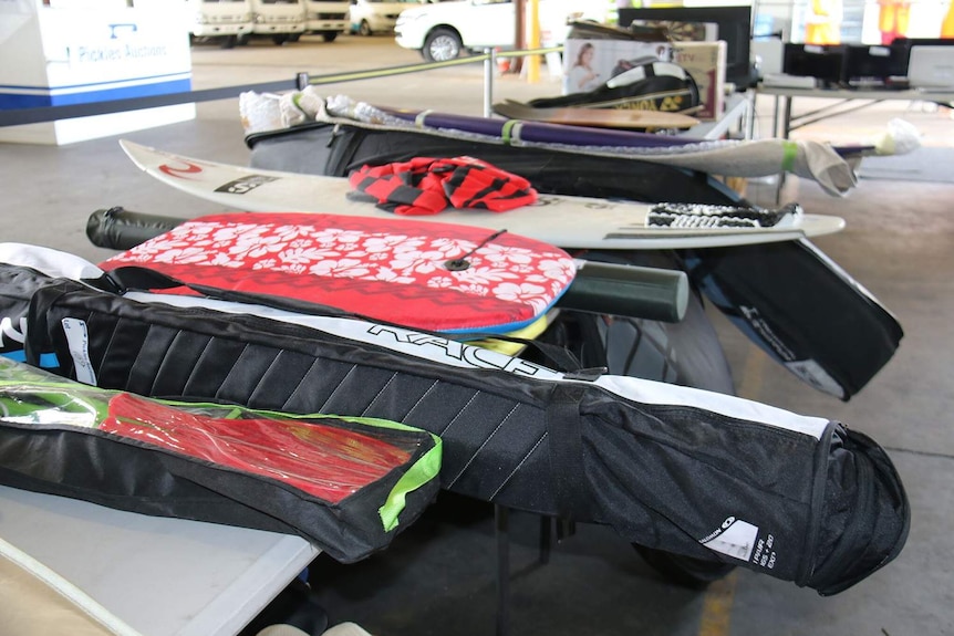 Some of the surfboards up for public auction after being left at Brisbane airport.