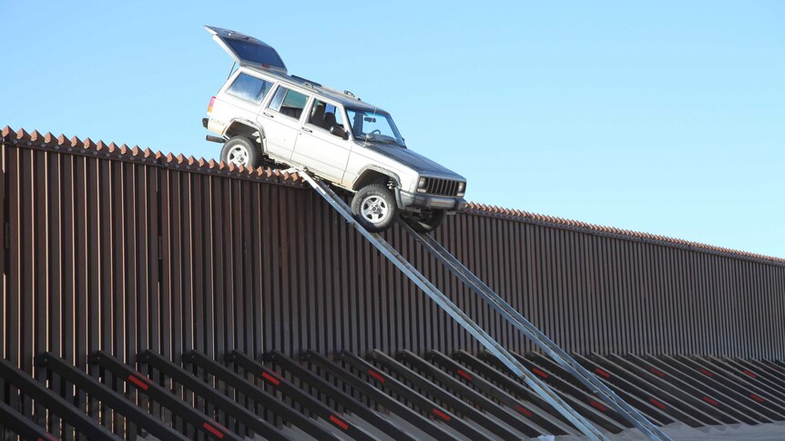 Car stuck atop US-Mexico border fence