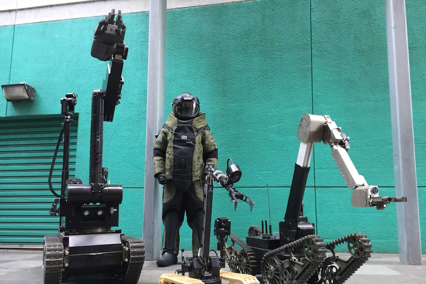 Three robots and a bomb squad suit