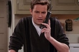 Chandler from Friends waves hands in air