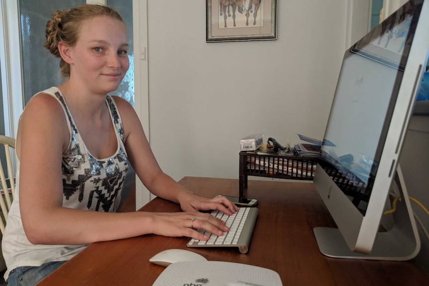 A woman typing at a computer