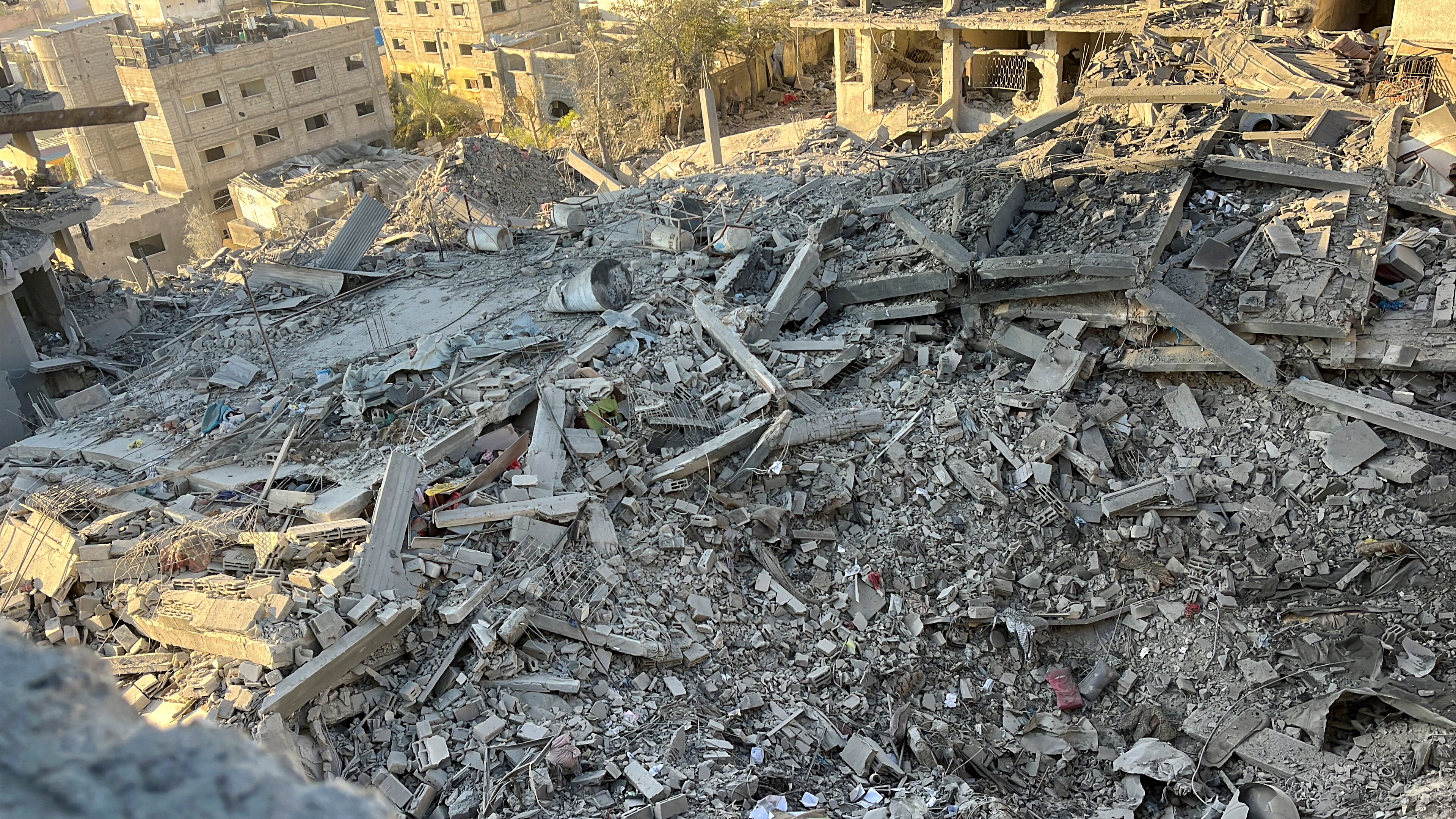 A multi-storey residential building lies in ruins following an Israeli strike.