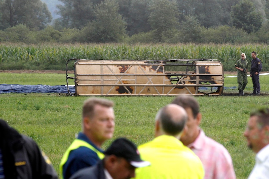 Police officers inspect the site where the hot-air balloon crashed.