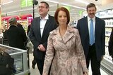 Prime Minister Julia Gillard walks through a Coles supermarket