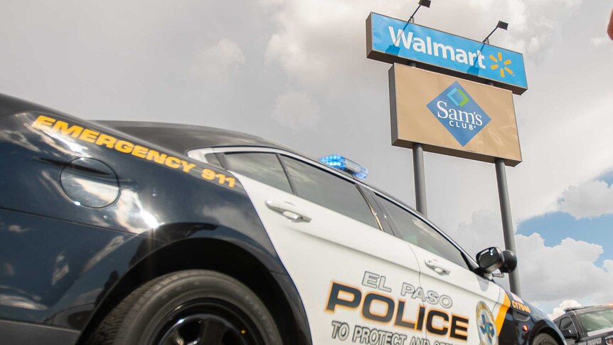 Two police cars parked near a sign reading 'Walmart'