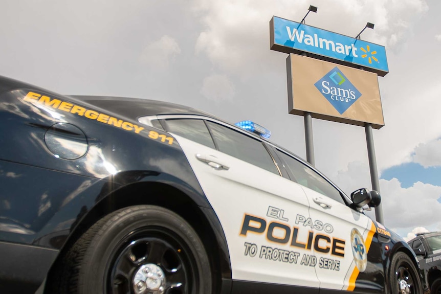 Two police cars parked near a sign reading 'Walmart'